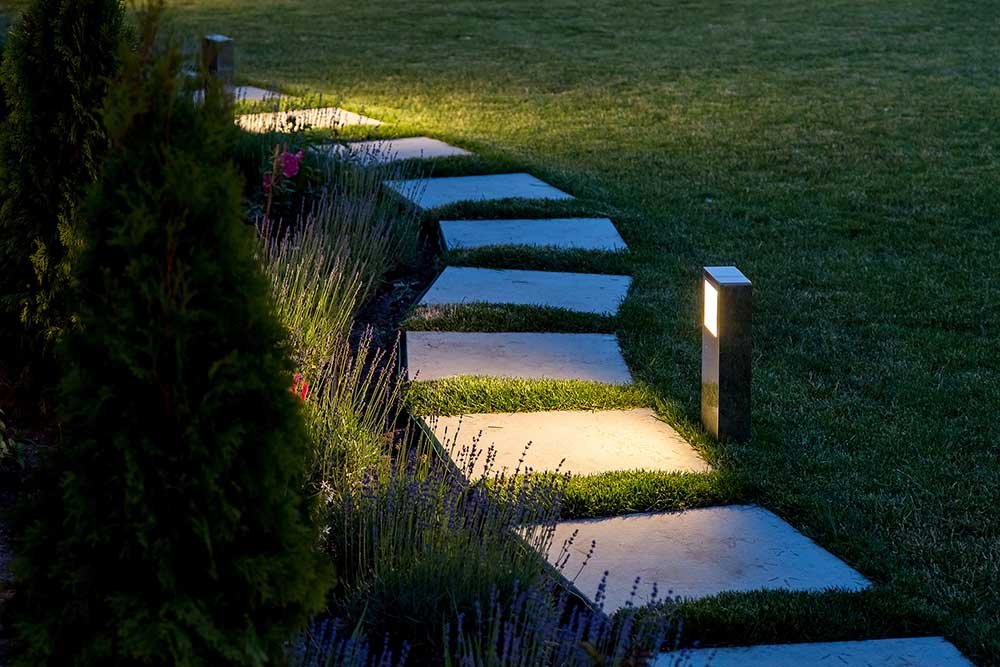marble path of square tiles illuminated by a lantern glowing wit