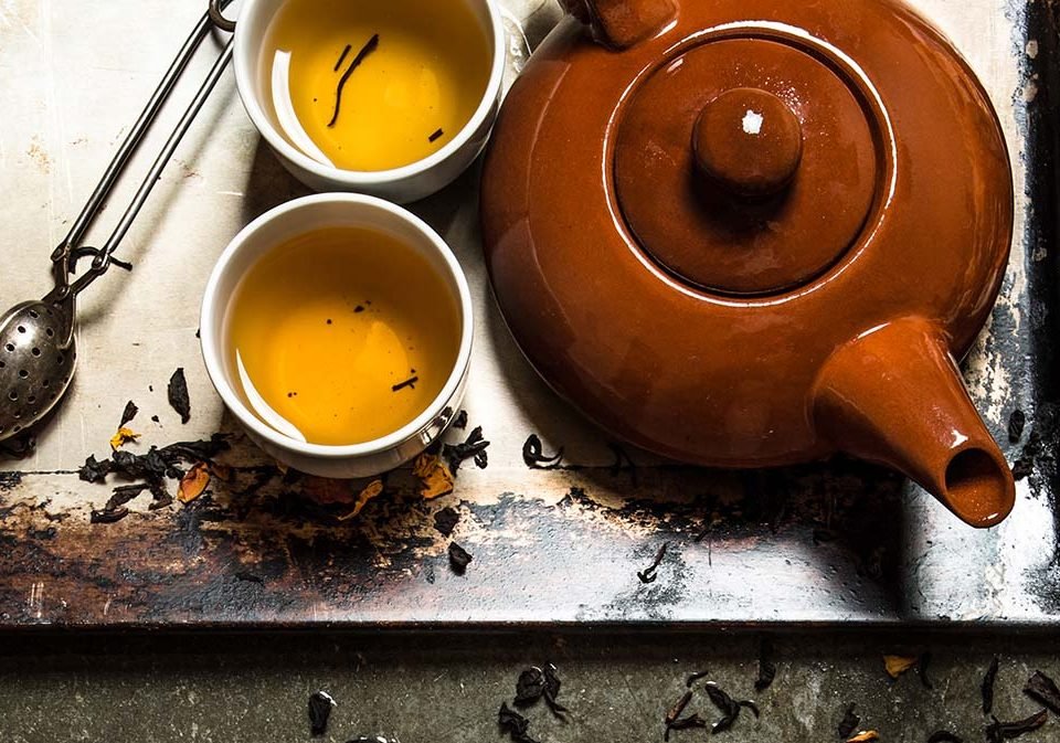 Fragrant tea brewed in a teapot. On the stone table.